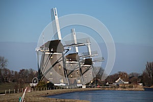 Three windmills in a row at a pool to keep the Driemanspolder dr