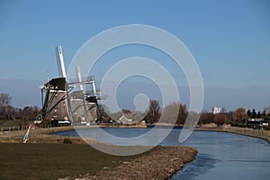 Three windmills in a row at a pool to keep the Driemanspolder dr