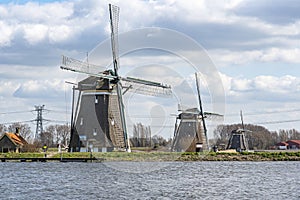 The three windmills Tweemanspolder nr 1,2 and 3 are located on the Rottemeren during a sunny and windy day with beautiful skies