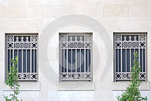 Three windows with metal grates