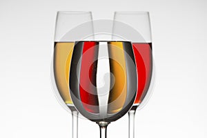 Three wineglasses different colour fluids that distort refraction