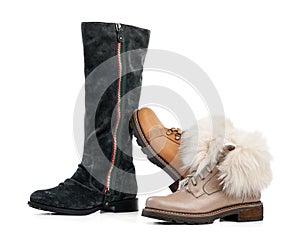 Three winter female boots over white