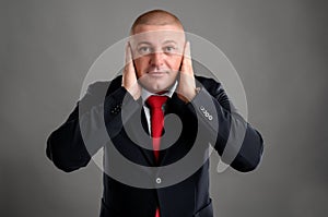 Three wise businessman that they did not hear, dressed in black suit