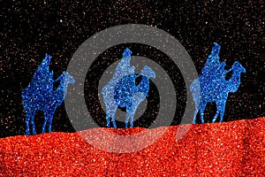 The three wise men from the east ride their camels to Bethlehem on a starry night