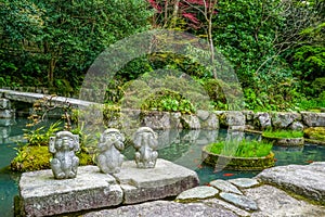 Three wise monkeys. Hear no evil, see no evil, speak no evil in a Japanese garden, Japan.