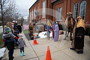 The three wisemen stand with Shadrach the camel