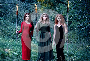 Three witches with with torches