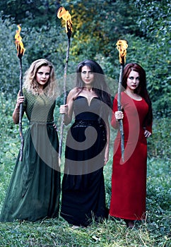 Three witches with with torches