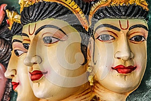 Three woman faces made of stone in Hindu temple