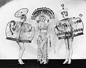Three woman in ornate teapot costumes photo