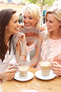 Three Women Enjoying Cup Of Coffee