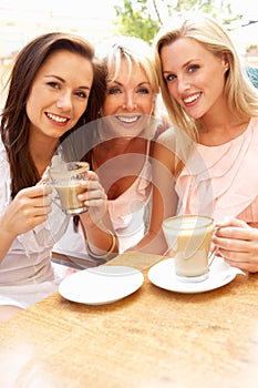 Three Women Enjoying Cup Of Coffee