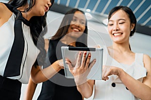 Three women friends chat with tablet computer. uds