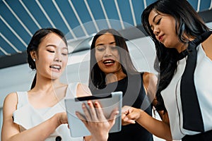 Three women friends chat with tablet computer. uds