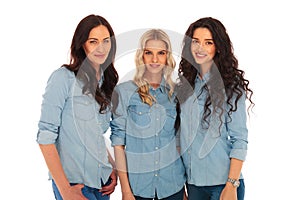 Three women friends standing together