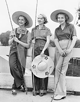 Three Women going fishing with huge hats photo