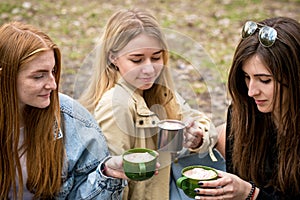 Three women with hot cocoa, close-up