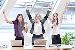 Three women jubilantly