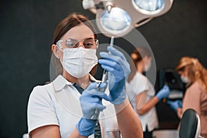 Three women in the room. Doctor with equipment. In the stomatological cabinet