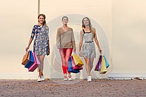 Three Women with Shopping Bags on walk