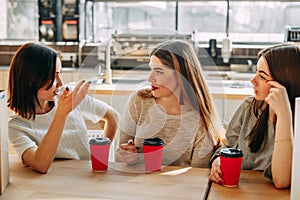 Three women sitting at cafe talking