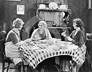 Three women sitting at the dining table talking