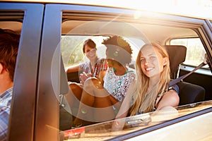 Three Women Sitting In Rear Seat Of Car On Road Trip