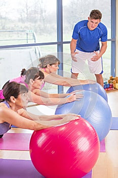 Three women stretching at the gym