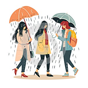 Three women walk together under rain, holding umbrellas, conversing, wearing casual clothing photo