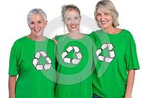 Three women wearing green recycling tshirts smiling at camera