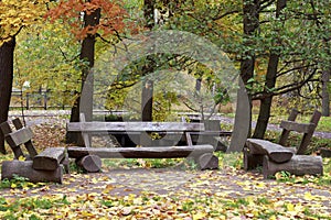 Three wooden benches in the autumn park.