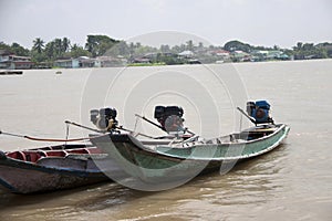 Three wooden boat machine landing on the water in the river.