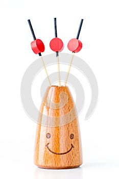 Three wooden canape sticks in wooden bottle and smile isolated o