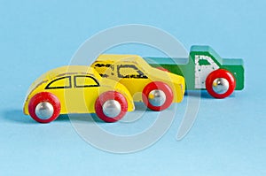 Three wooden cars toys on azure background