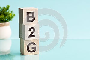 Three wooden cubes with letters b2g - short for business to government, concept