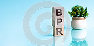 Three wooden cubes with letters BPR - short for Business process reengineering, concept