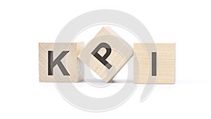 three wooden cubes with the letters KPI on white table. Key Performance Indicators concept