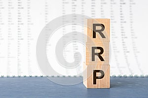 Three wooden cubes with letters RRP - short for Recommended Retail Price, concept