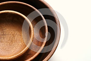 Three wooden empty food bowls stacked on top of each other