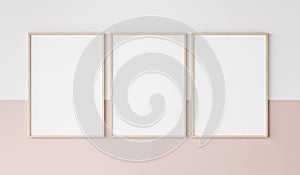 Three wooden frames on pink and white wall, frame mockup