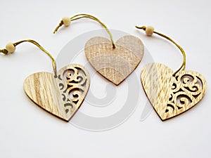 Three wooden hearts with patterns isolated on white background.