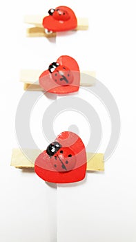 Three Wooden Ladybugs on Heart Shape Clips
