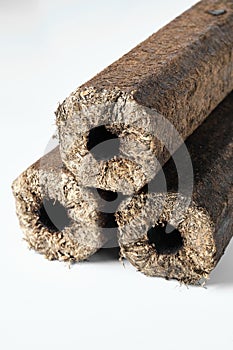 Three wooden pressed briquettes Pini Kay from biomass