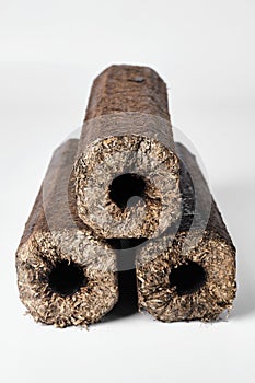 Three wooden pressed briquettes Pini Kay from biomass