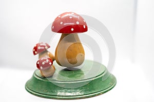 three wooden toadstools on a white background