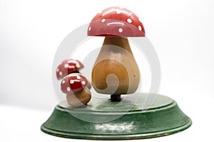 three wooden toadstools on a white background