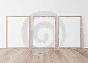 Minimal frame mock up interior, Three wooden vertical frames Standing on parquet floor with white background photo