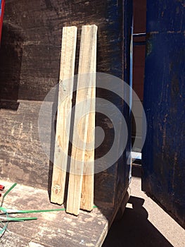 Three Wooden 2x4s in a Construction Dumpster