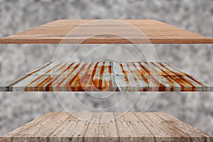 Three wooden and zinc floor shelves empty with blurred stone wall background. for product display