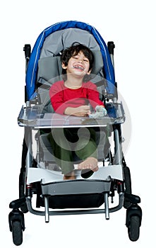 Three year old biracial disabled boy in medical stroller, happy